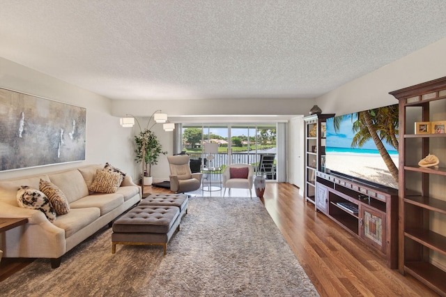 1320 NW 20th Ave Unit 202, Delray Beach, FL 33445 - living room with wood finished floors and a textured ceiling