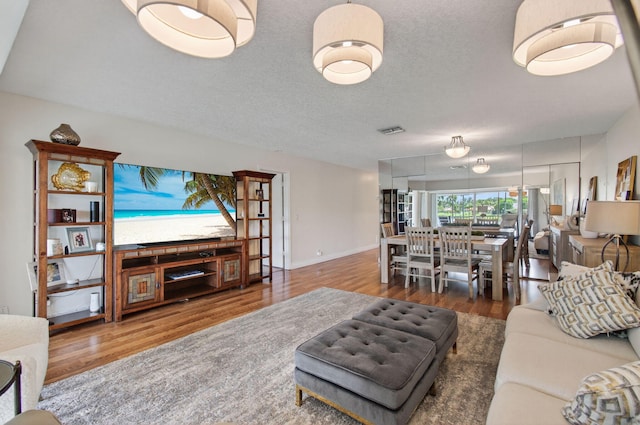 1320 NW 20th Ave Unit 202, Delray Beach, FL 33445 - living area with wood finished floors and a textured ceiling