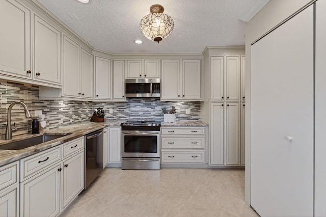 1320 NW 20th Ave Unit 202, Delray Beach, FL 33445 - kitchen with stainless steel appliances, light stone counters, backsplash, and a textured ceiling