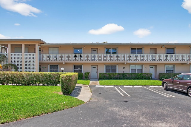 1320 NW 20th Ave Unit 202, Delray Beach, FL 33445 - view of building exterior featuring uncovered parking