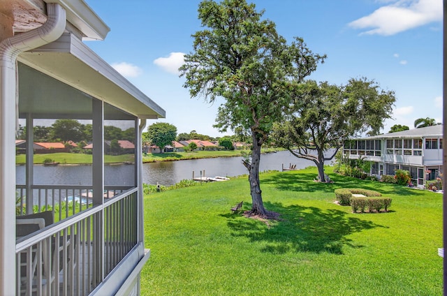 1320 NW 20th Ave Unit 202, Delray Beach, FL 33445 - view of green lawn with a water view and a sunroom