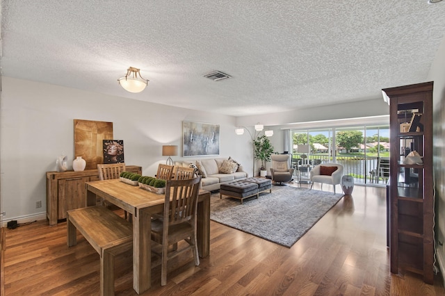1320 NW 20th Ave Unit 202, Delray Beach, FL 33445 - dining area with wood finished floors and a textured ceiling