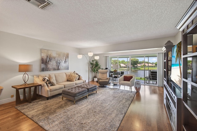 1320 NW 20th Ave Unit 202, Delray Beach, FL 33445 - living area featuring a textured ceiling, wood finished floors, and a water view