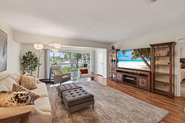 1320 NW 20th Ave Unit 202, Delray Beach, FL 33445 - living room featuring a textured ceiling and wood finished floors