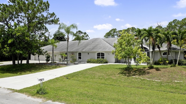 3283 SE W Snow Rd, Port Saint Lucie, FL 34984 - ranch-style house with a front yard, stucco siding, and driveway