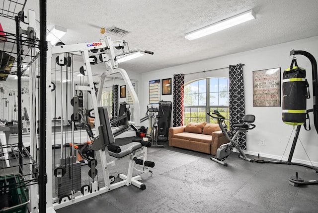 3283 SE W Snow Rd, Port Saint Lucie, FL 34984 - exercise room featuring a textured ceiling
