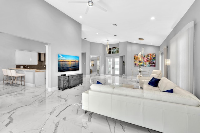 20677 NW 26th Ct, Boca Raton, FL 33434 - living room with recessed lighting, light marble finish floors, a ceiling fan, high vaulted ceiling, and baseboards