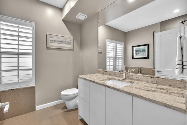 20677 NW 26th Ct, Boca Raton, FL 33434 - bathroom featuring toilet, vanity, baseboards, and recessed lighting
