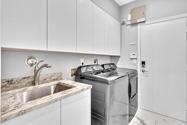 20677 NW 26th Ct, Boca Raton, FL 33434 - laundry area featuring washing machine and clothes dryer, cabinet space, and light marble finish flooring