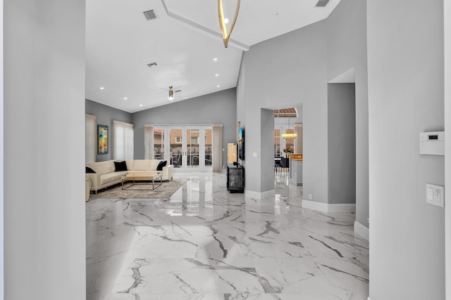 20677 NW 26th Ct, Boca Raton, FL 33434 - living area with marble tiled floors, french doors, recessed lighting, baseboards, and high vaulted ceiling