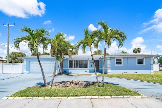 1209 N Australian Ave, West Palm Beach, FL 33401 - ranch-style home featuring curved driveway, an attached garage, and stucco siding