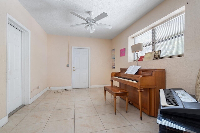 1209 N Australian Ave, West Palm Beach, FL 33401 - living area featuring ceiling fan, a textured ceiling, and light tile patterned flooring