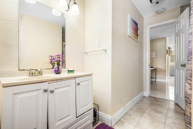 1209 N Australian Ave, West Palm Beach, FL 33401 - bathroom featuring tile patterned floors, a textured wall, and vanity