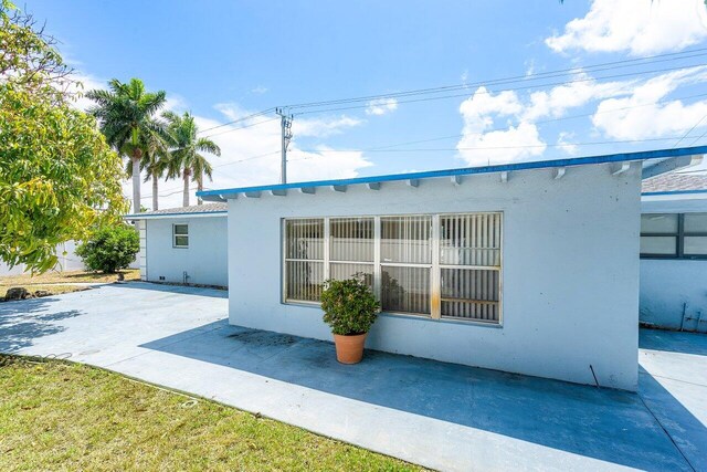1209 N Australian Ave, West Palm Beach, FL 33401 - rear view of property featuring a patio area and stucco siding
