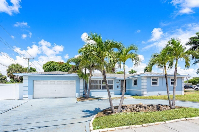 1209 N Australian Ave, West Palm Beach, FL 33401 - single story home featuring concrete driveway, an attached garage, and stucco siding