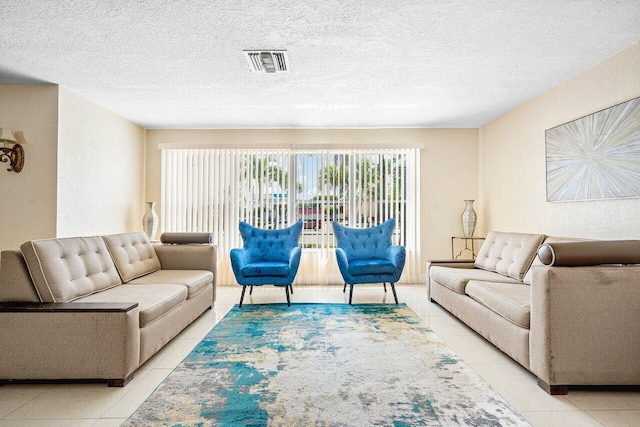 1209 N Australian Ave, West Palm Beach, FL 33401 - living area with tile patterned floors and a textured ceiling