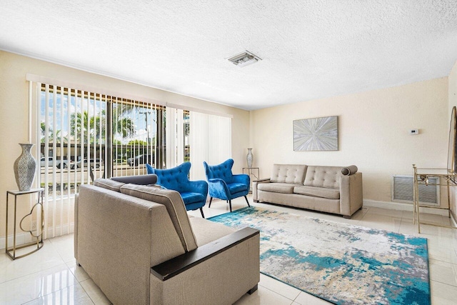 1209 N Australian Ave, West Palm Beach, FL 33401 - living area featuring light tile patterned floors and a textured ceiling