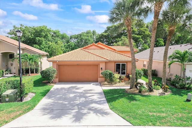 8073 Pelican Harbour Dr, Lake Worth, FL 33467 - mediterranean / spanish-style house with stucco siding, a tiled roof, an attached garage, concrete driveway, and a front yard
