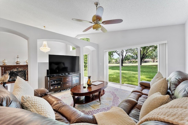 8073 Pelican Harbour Dr, Lake Worth, FL 33467 - tiled living area with arched walkways, ceiling fan, a textured ceiling, and vaulted ceiling