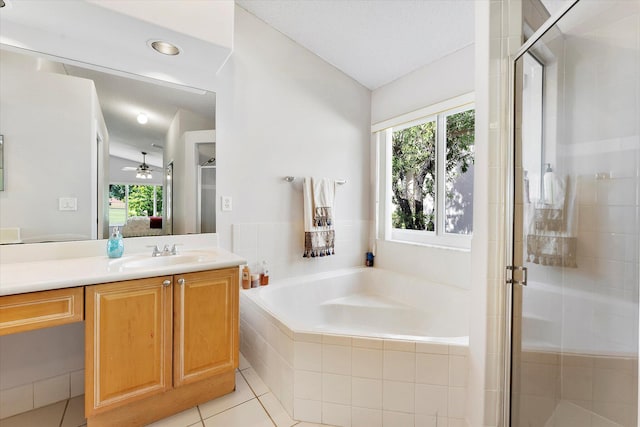 8073 Pelican Harbour Dr, Lake Worth, FL 33467 - ensuite bathroom with vanity, a garden tub, a shower stall, tile patterned flooring, and lofted ceiling