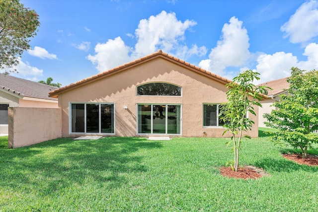 8073 Pelican Harbour Dr, Lake Worth, FL 33467 - rear view of property with stucco siding, a lawn, and a tiled roof