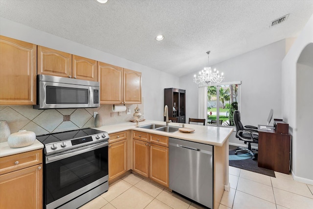 8073 Pelican Harbour Dr, Lake Worth, FL 33467 - kitchen with appliances with stainless steel finishes, a textured ceiling, a peninsula, light countertops, and lofted ceiling