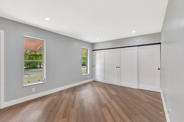 5073 Lakefront Blvd Unit D, Delray Beach, FL 33484 - unfurnished bedroom with wood finished floors, recessed lighting, and a closet