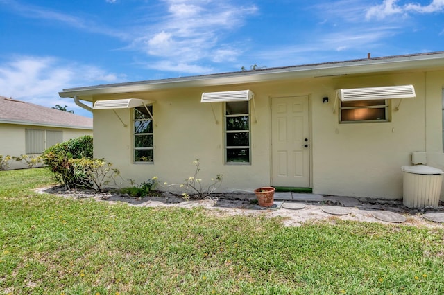 5073 Lakefront Blvd Unit D, Delray Beach, FL 33484 - property entrance with stucco siding and a yard