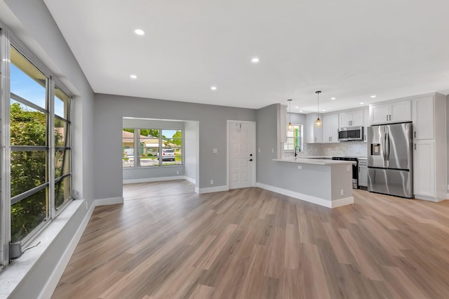 5073 Lakefront Blvd Unit D, Delray Beach, FL 33484 - unfurnished living room featuring light wood finished floors and recessed lighting