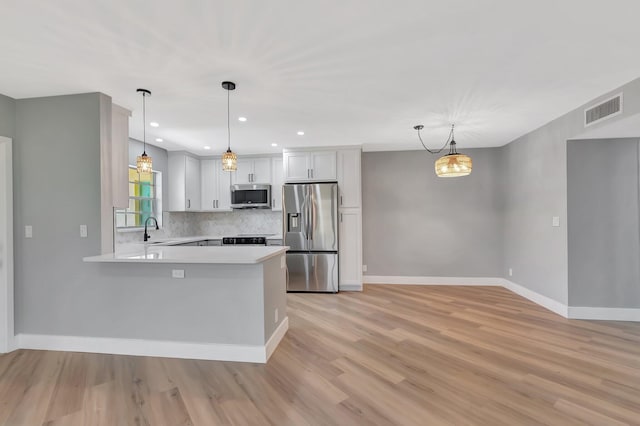 5073 Lakefront Blvd Unit D, Delray Beach, FL 33484 - kitchen with appliances with stainless steel finishes, light countertops, tasteful backsplash, light wood-style floors, and recessed lighting