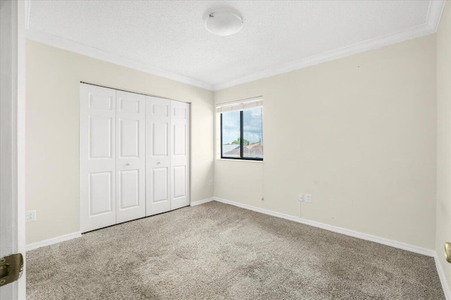 18103 SW 143rd Pl, Miami, FL 33177 - unfurnished bedroom with carpet flooring, a textured ceiling, ornamental molding, and a closet