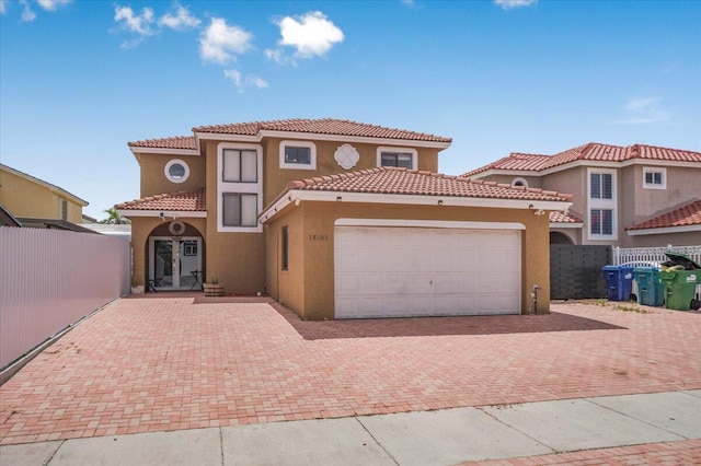 18103 SW 143rd Pl, Miami, FL 33177 - mediterranean / spanish house featuring stucco siding, an attached garage, decorative driveway, and a tiled roof