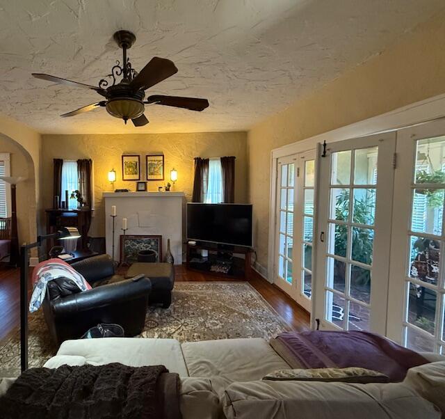 616 37th St, West Palm Beach, FL 33407 - living room featuring wood finished floors, ceiling fan, and a textured ceiling
