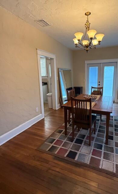 616 37th St, West Palm Beach, FL 33407 - dining area featuring a chandelier, hardwood / wood-style flooring, and french doors