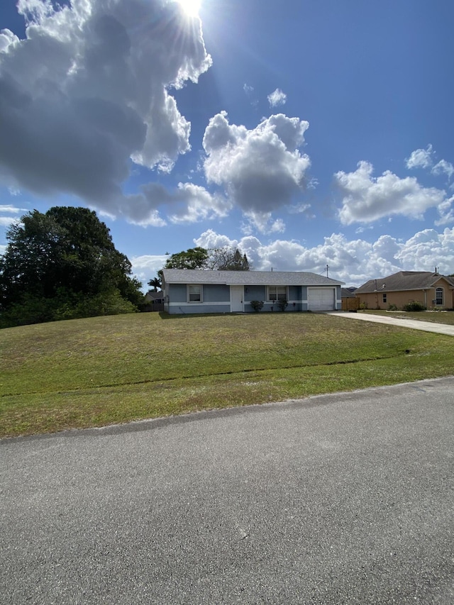 649 SW Heather St, Port Saint Lucie, FL 34983 - single story home featuring driveway, a garage, and a front lawn