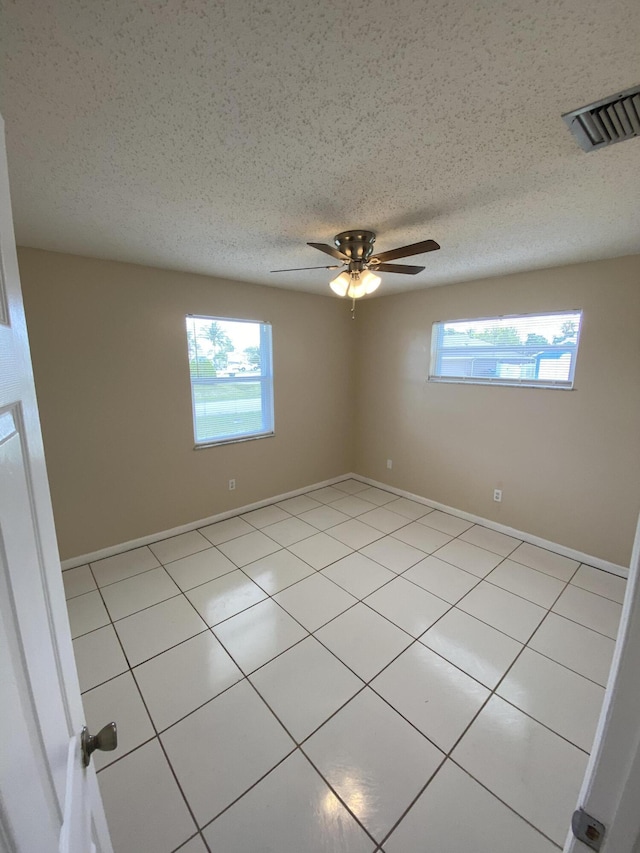 649 SW Heather St, Port Saint Lucie, FL 34983 - empty room with plenty of natural light, ceiling fan, and light tile patterned floors