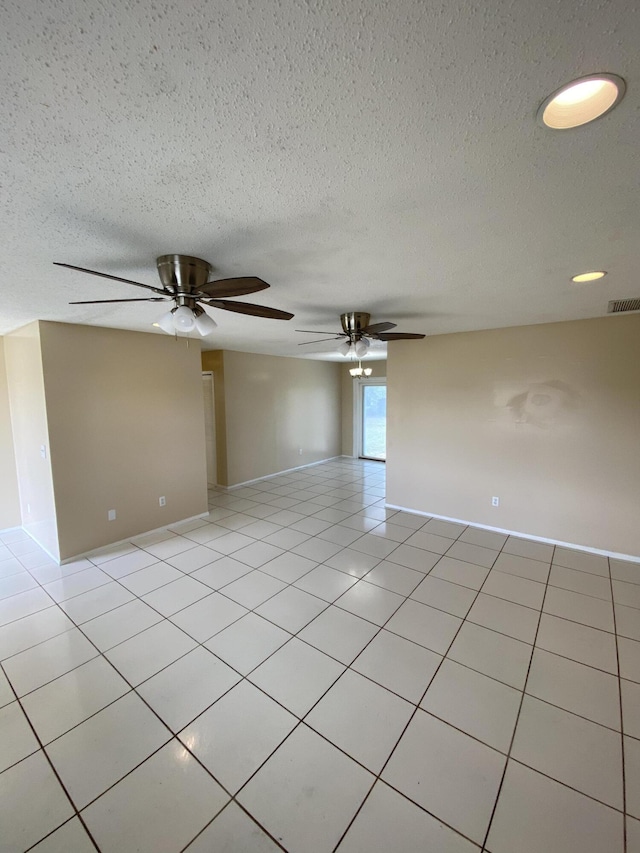 649 SW Heather St, Port Saint Lucie, FL 34983 - unfurnished room with a ceiling fan, light tile patterned floors, and a textured ceiling
