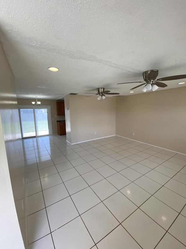 649 SW Heather St, Port Saint Lucie, FL 34983 - empty room with light tile patterned floors, a textured ceiling, a ceiling fan, baseboards, and recessed lighting