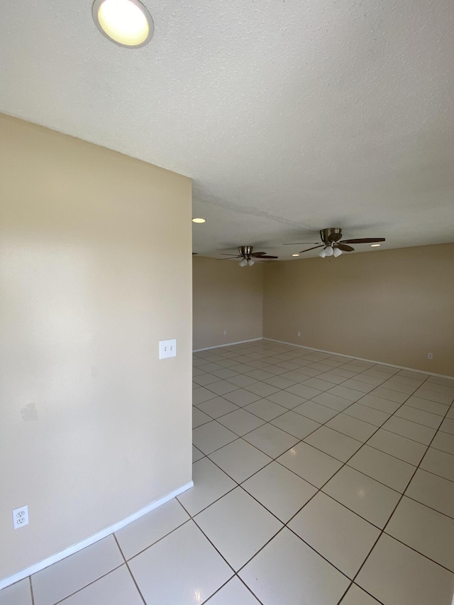 649 SW Heather St, Port Saint Lucie, FL 34983 - unfurnished room featuring baseboards, a ceiling fan, light tile patterned floors, and a textured ceiling