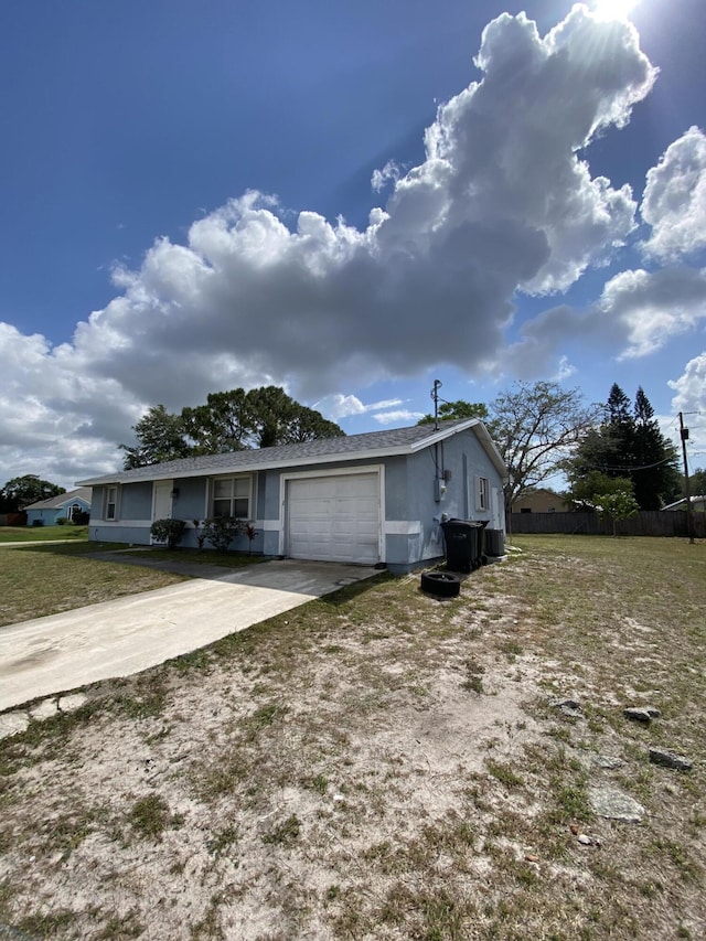 649 SW Heather St, Port Saint Lucie, FL 34983 - view of front facade with an attached garage, concrete driveway, and stucco siding