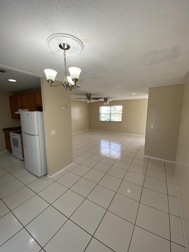 649 SW Heather St, Port Saint Lucie, FL 34983 - unfurnished room with a ceiling fan, a textured ceiling, light tile patterned floors, and baseboards