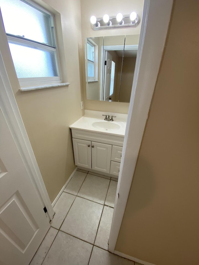 649 SW Heather St, Port Saint Lucie, FL 34983 - bathroom with tile patterned floors, vanity, and baseboards