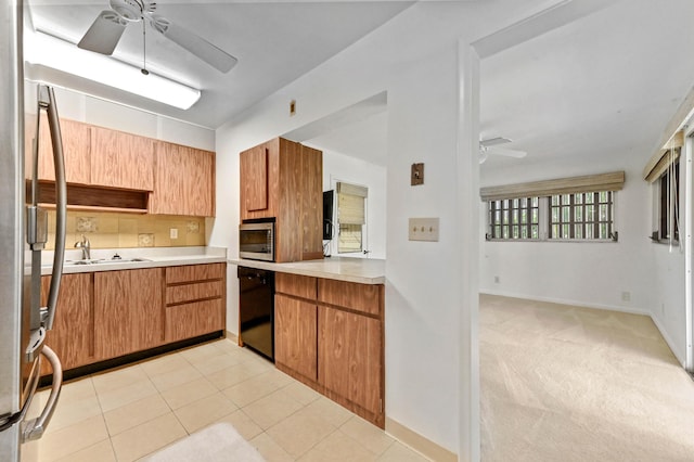 436 Santa Anna Dr, Palm Springs, FL 33461 - kitchen featuring a ceiling fan, appliances with stainless steel finishes, light countertops, and brown cabinets