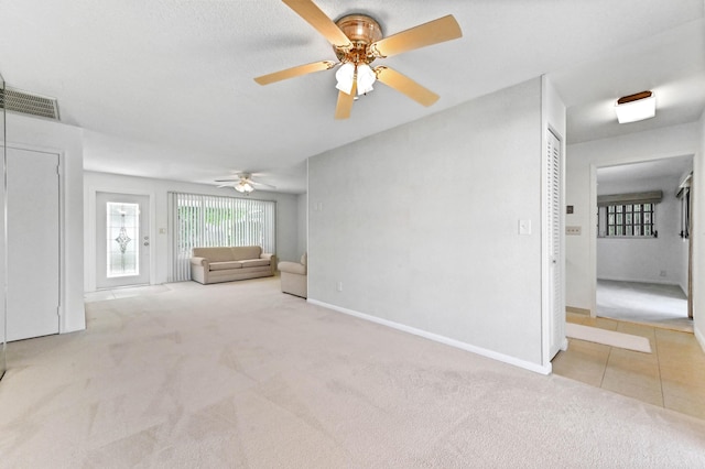 436 Santa Anna Dr, Palm Springs, FL 33461 - unfurnished living room featuring carpet flooring, a ceiling fan, plenty of natural light, and tile patterned floors
