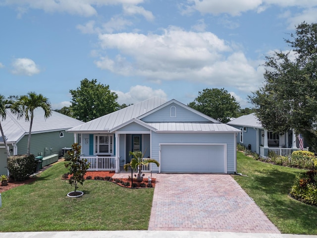 424 NE Leaping Frog Way, Port Saint Lucie, FL 34983 - single story home with covered porch, a garage, decorative driveway, and a front lawn