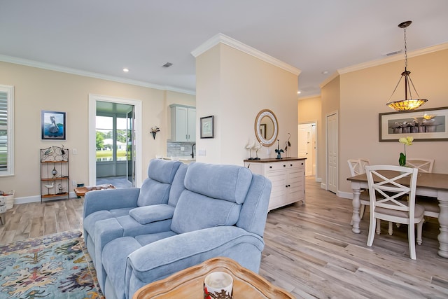 424 NE Leaping Frog Way, Port Saint Lucie, FL 34983 - living area with light wood-style flooring, crown molding, baseboards, and recessed lighting