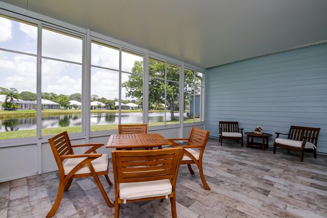 424 NE Leaping Frog Way, Port Saint Lucie, FL 34983 - sunroom with a water view and outdoor dining space