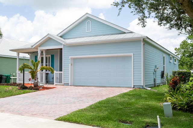 424 NE Leaping Frog Way, Port Saint Lucie, FL 34983 - single story home with covered porch, a garage, decorative driveway, and a front lawn