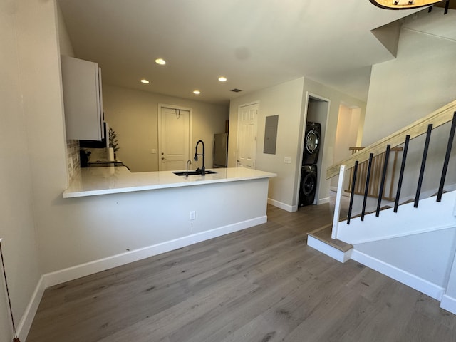 2799 Saranac Ave, West Palm Beach, FL 33409 - kitchen featuring stacked washer / drying machine, recessed lighting, freestanding refrigerator, wood finished floors, and electric panel