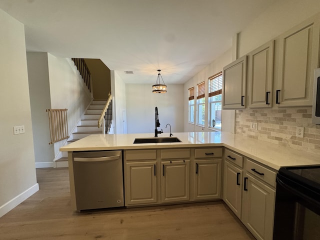2799 Saranac Ave, West Palm Beach, FL 33409 - kitchen with stainless steel dishwasher, a peninsula, light countertops, decorative backsplash, and black electric range oven